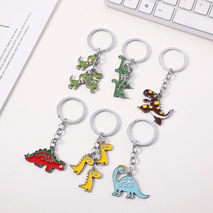 Flat lay of colorful enamel dinosaur keychains in six cute cartoon designs for bags