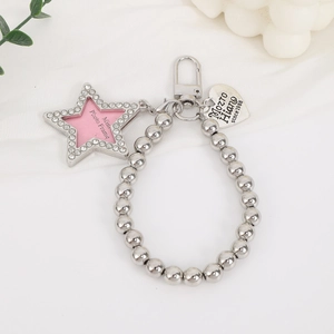 Close-up of silver beaded chain with star photo frame and engraved heart pendant