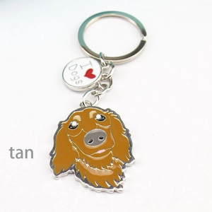 Detail view of a tan dog metal keychain with I Love Dogs charm and golden keyring