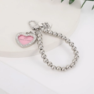 Silver heart photo locket pendant with rhinestones and bead chain on white display
