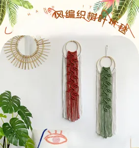 Detail of bohemian leaf-shaped woven tapestry with wooden ring and tassel fringe decor