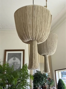Detailed close-up of large bohemian macrame lampshade with dense cotton fringe and weaving