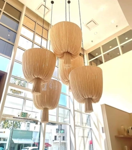 Macro shot of tiered Nordic hand-woven cotton fringe chandeliers in a modern interior space