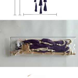 Detail of macrame photo holder with purple tassels, wooden rod, and clips, 45cm width