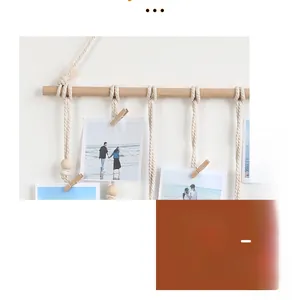 Detail of hand-woven cotton macrame photo hanging wall decor with wooden beads and clips