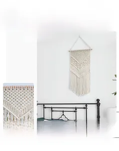 Close-up of geometric weaving details and tassels on handmade boho wall tapestry
