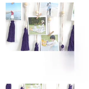 Detail of bohemian woven cotton rope photo hanger with wooden beads and purple tassels