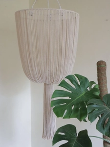 Detail of bohemian ivory cotton rope lampshade with long fringe in Nordic style decor