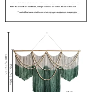 Detail of bohemian woven tapestry with green gradient tassels and wooden beads