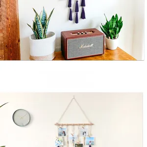 Close-up of bohemian woven cotton rope photo display with natural wooden clips