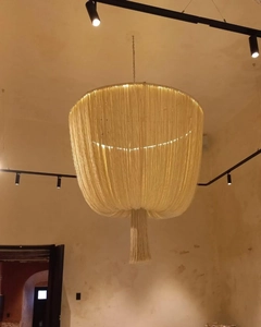 Detailed view of handmade bohemian cotton cord lampshade with warm hanging fringe