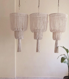 Detail of bohemian hand-woven cotton lamp shades with three-tier fringe layers