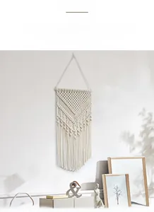 Detail of bohemian macramé wall hanging with handwoven cotton rope textures and tassels