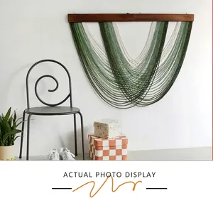 Bohemian wall decor detail with multi-layered green cotton woven tapestry on wood