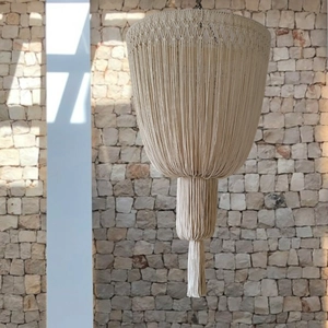 Detailed close-up of handmade Bohemian macrame lampshade with cotton tassels