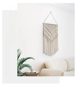 Close-up of bohemian woven tapestry detail with cotton rope geometric patterns and fringe