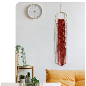 Detailed macro view of hand-woven cotton leaf and tassel patterns on boho wall hanging