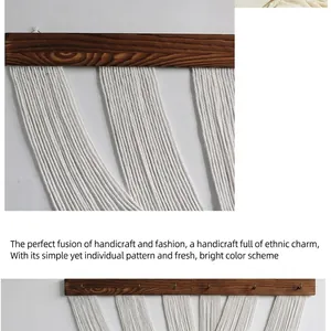 Detail of bohemian handmade woven wall hanging featuring natural white cotton rope and wood
