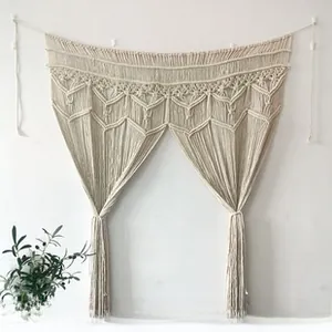 Close-up of bohemian hand-woven macrame tapestry featuring intricate knots and cotton tassels