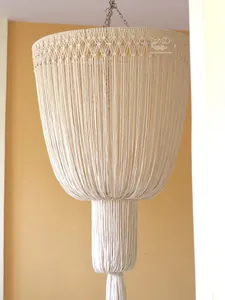 Detailed macro of bohemian macrame woven lampshade with cotton tassels and fringe