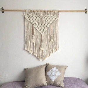 Detailed macro view of Bohemian handwoven macrame wall hanging with fringe and tassels