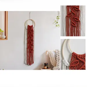 Detail of bohemian woven wall decor showing terracotta leaf patterns and cotton tassels