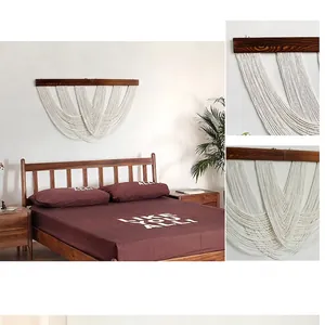 Detail of bohemian hand-woven cotton tapestry with wooden rod and fringe textures