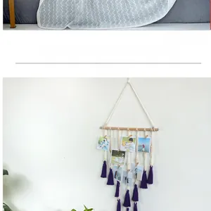Detail of macrame photo display hanging with wooden clips and purple tassels