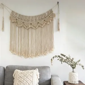 Close-up of bohemian hand-woven cotton tapestry featuring geometric patterns and tassels