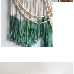 Detail of bohemian wall hanging featuring natural wood beads and green gradient tassels