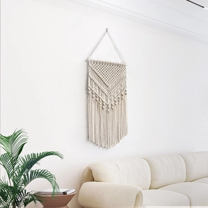 Handmade macrame wall hanging with geometric patterns and fringe for boho home decor