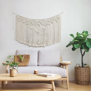 Detailed close-up of handmade Bohemian macrame wall hanging with cotton rope tassels
