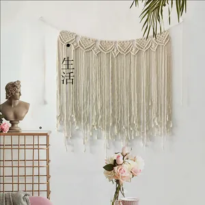 Detail of bohemian hand-woven macrame wall hanging with intricate fringe and cotton textures