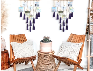 Detail of bohemian wall photo display featuring cotton ropes and purple tassels