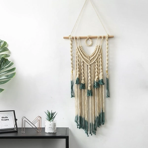 Handmade bohemian woven wall tapestry in beige and dark green with wooden rod hanger