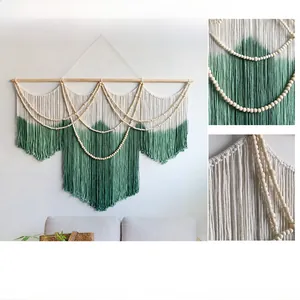 Detail of bohemian dip-dye cotton fringe and decorative wood beads on woven wall hanging