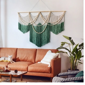 Close-up of woven cotton tapestry with emerald green dip-dye fringe and wood beads