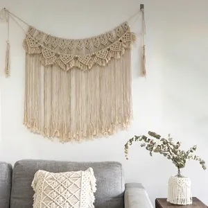 Close-up of bohemian macrame wall hanging with handmade cotton rope weaving and long tassels