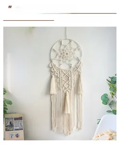 Macro detail of Bohemian hand-woven wall hanging with white cotton tassels and circular macrame