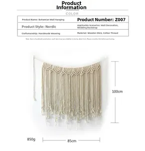 Detail view of handmade bohemian wall hanging woven from white cotton and wood