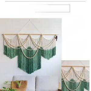 Detailed macro view of bohemian hand-woven cotton tapestry with forest green dip-dye fringe