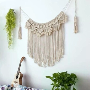 Detailed view of handmade bohemian wall tapestry with geometric patterns and tassels