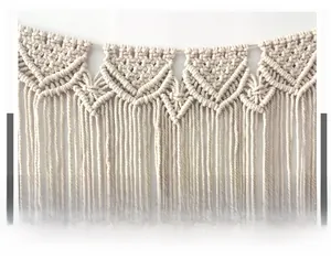 Macro shot of boho macrame wall hanging featuring hand-woven geometric knots and long tassels