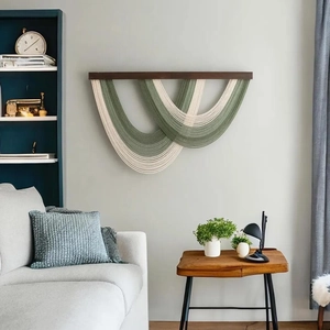Bohemian macrame wall hanging with green cotton ropes and tassels for home decor