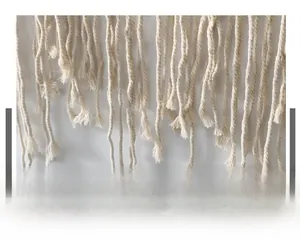 Detailed macro view of bohemian hand-woven cotton macrame fringe and rope texture
