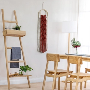 Handmade woven wall hanging tapestry with reddish-brown leaves and cream cotton tassels