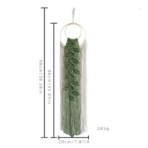 Handmade macrame wall hanging with cotton rope leaves and wood rings in beige and green