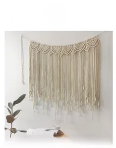 Detail of bohemian handmade cotton rope tapestry with geometric weave and long tassels