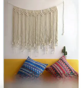 Detailed macro view of bohemian hand-woven macrame wall hanging with natural cotton fringe