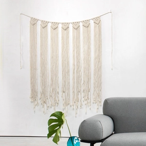 Detailed view of handmade macrame garland with seven woven triangles and cotton tassels